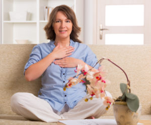 Woman using integrative cancer therapies on couch